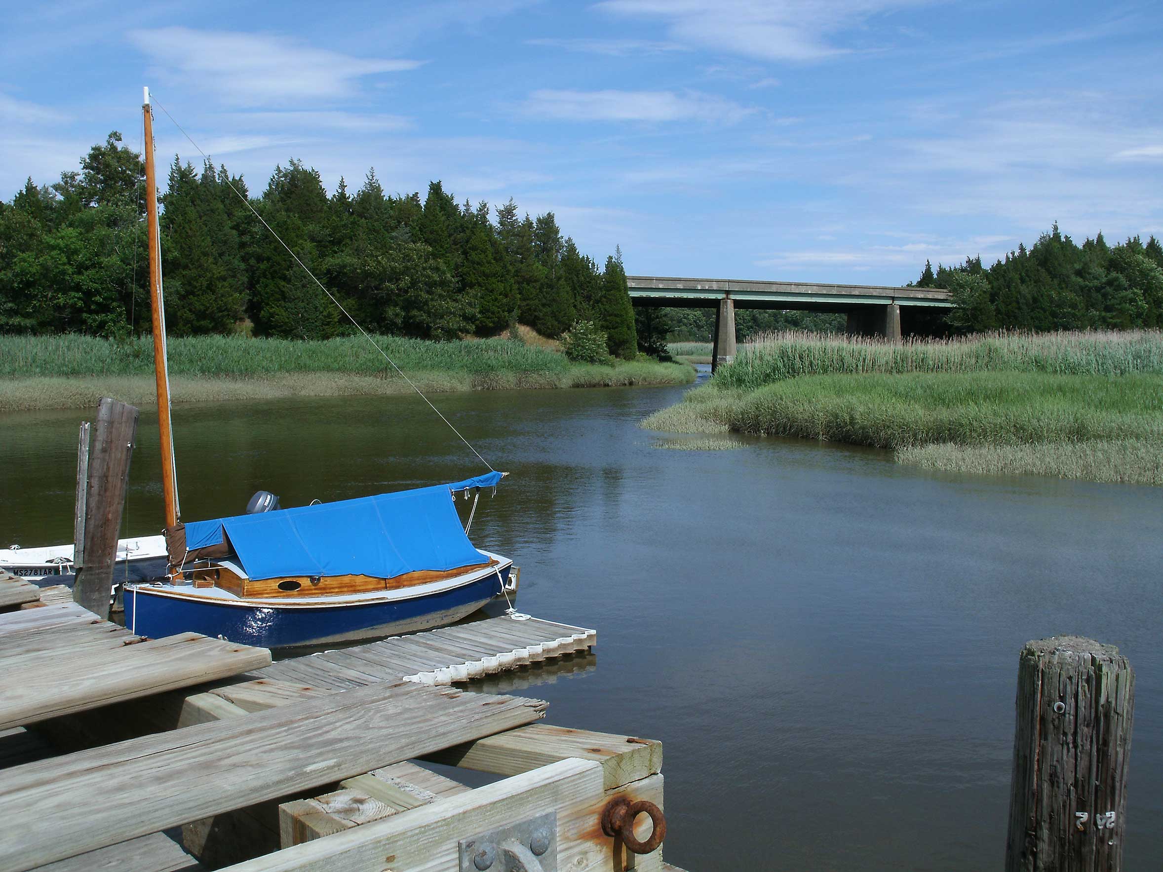 Photograph of Jones River with a boat on the dock in Kingston, MA